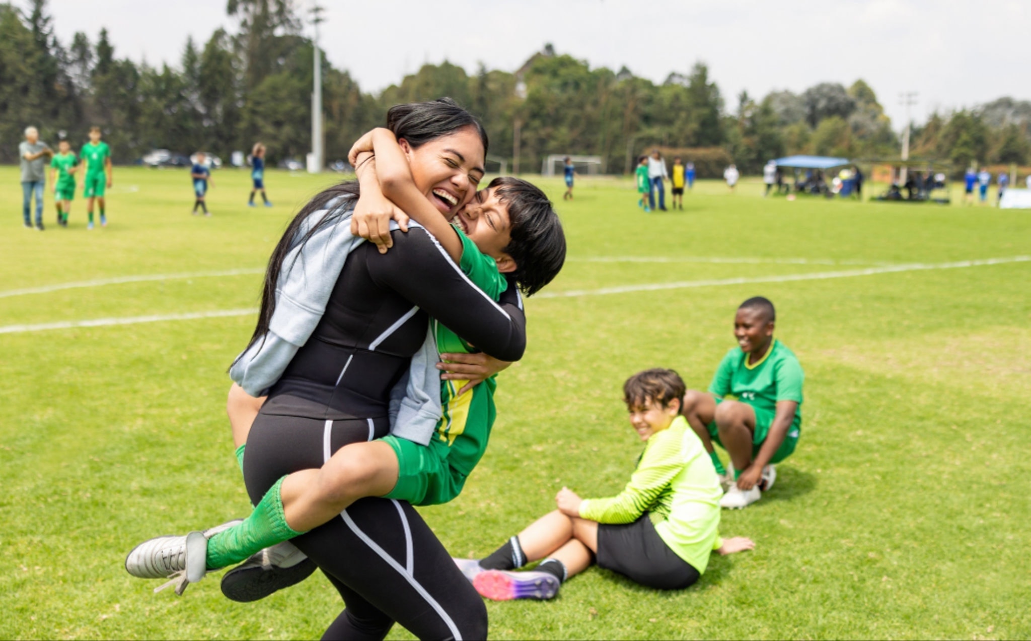 Young athlete celebrating a happy moment with their parent after a game