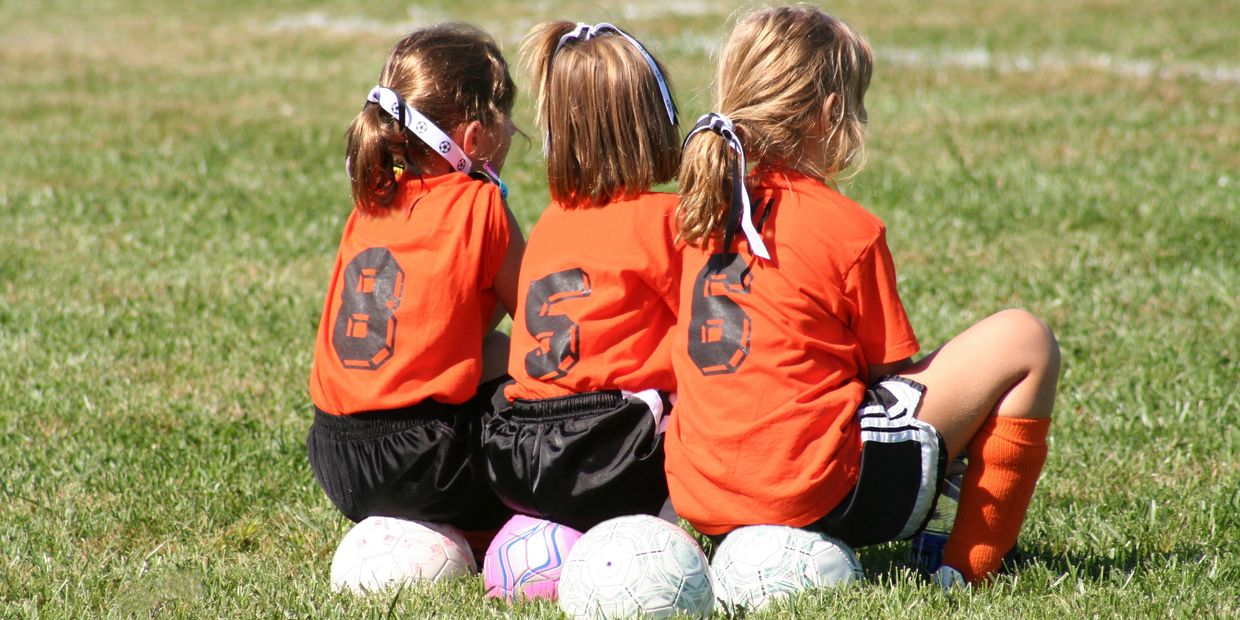 Girls playing soccer in action