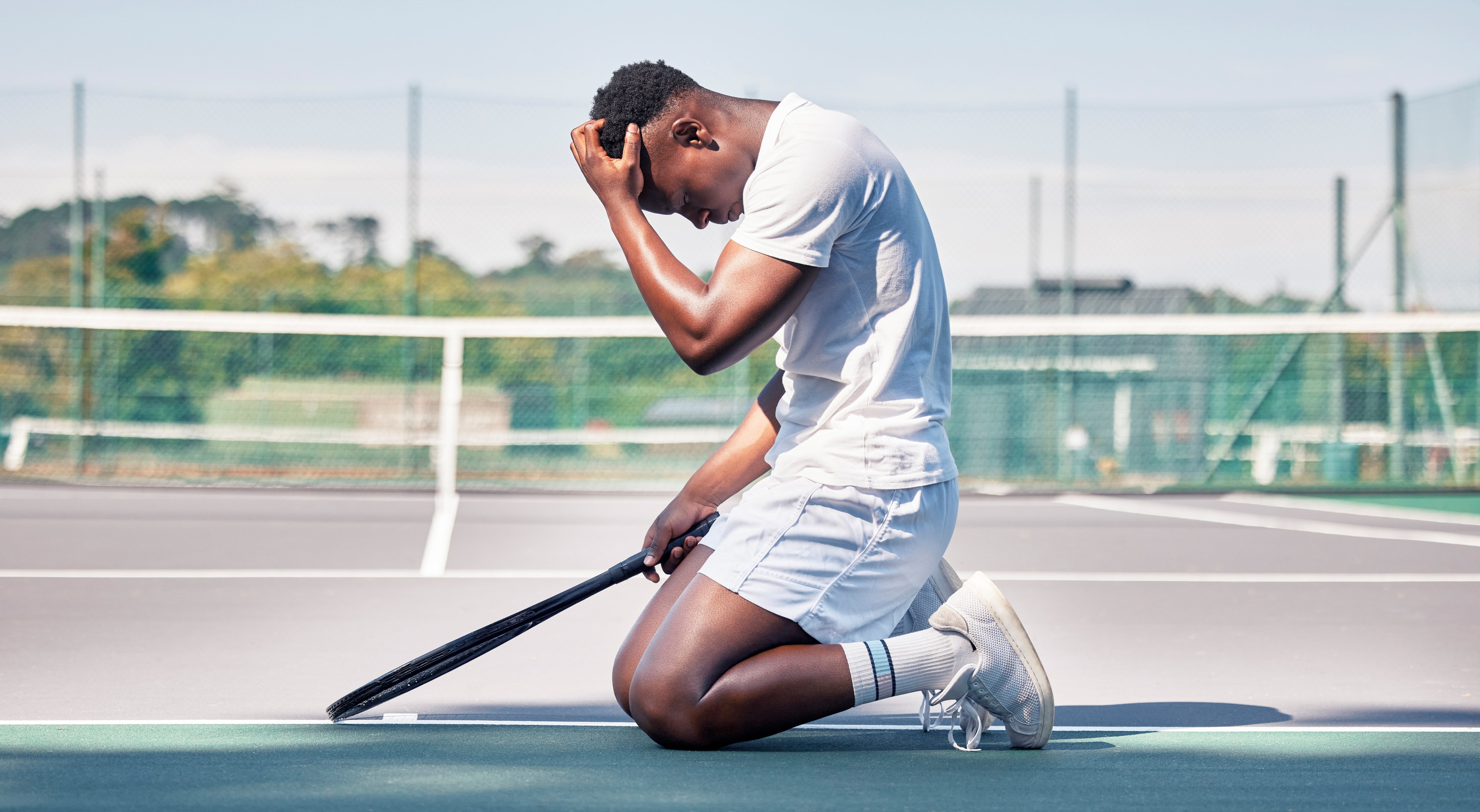 Young tennis player showing signs of stress and pressure