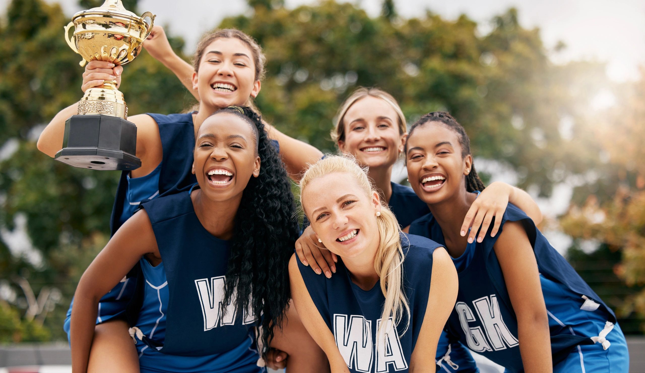Girls team celebrating with trophy